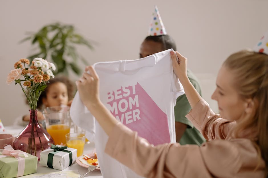 A joyful indoor Mother's Day celebration featuring a family with a 'Best Mom Ever' shirt.