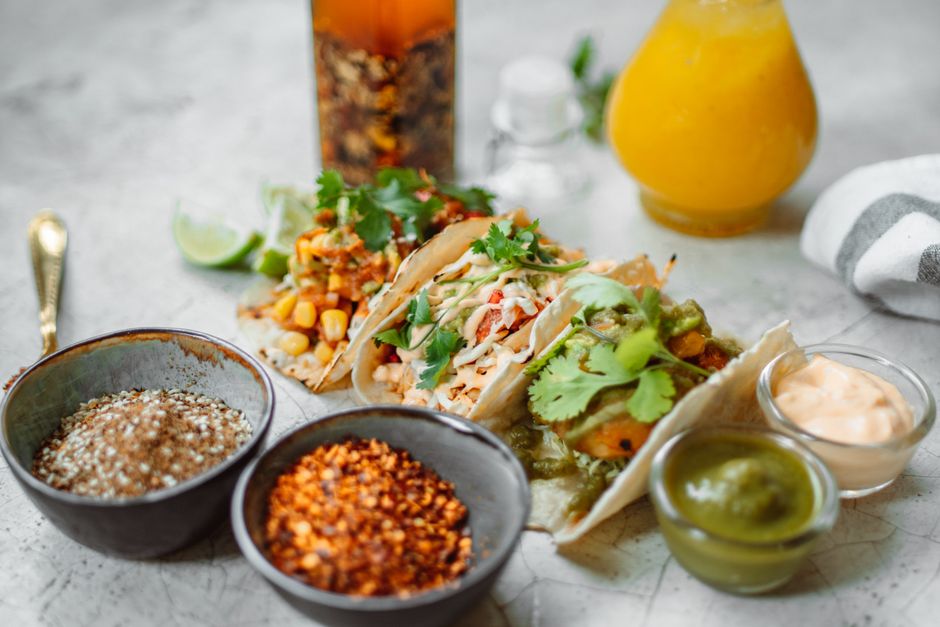 Close-up of Mexican tacos with diverse fillings, spices, and sauces, perfect for food lovers.