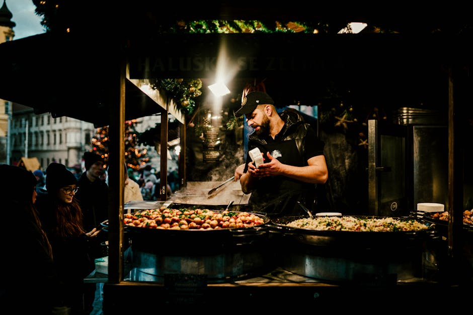 Chef prepares traditional street food at a lively European Christmas market.
